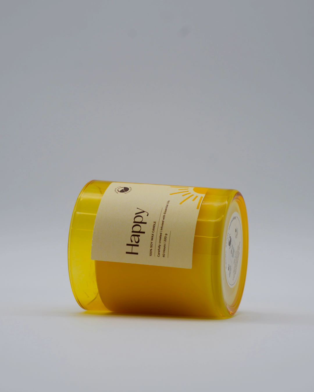 Yellow cylindrical container with a label on a gray background