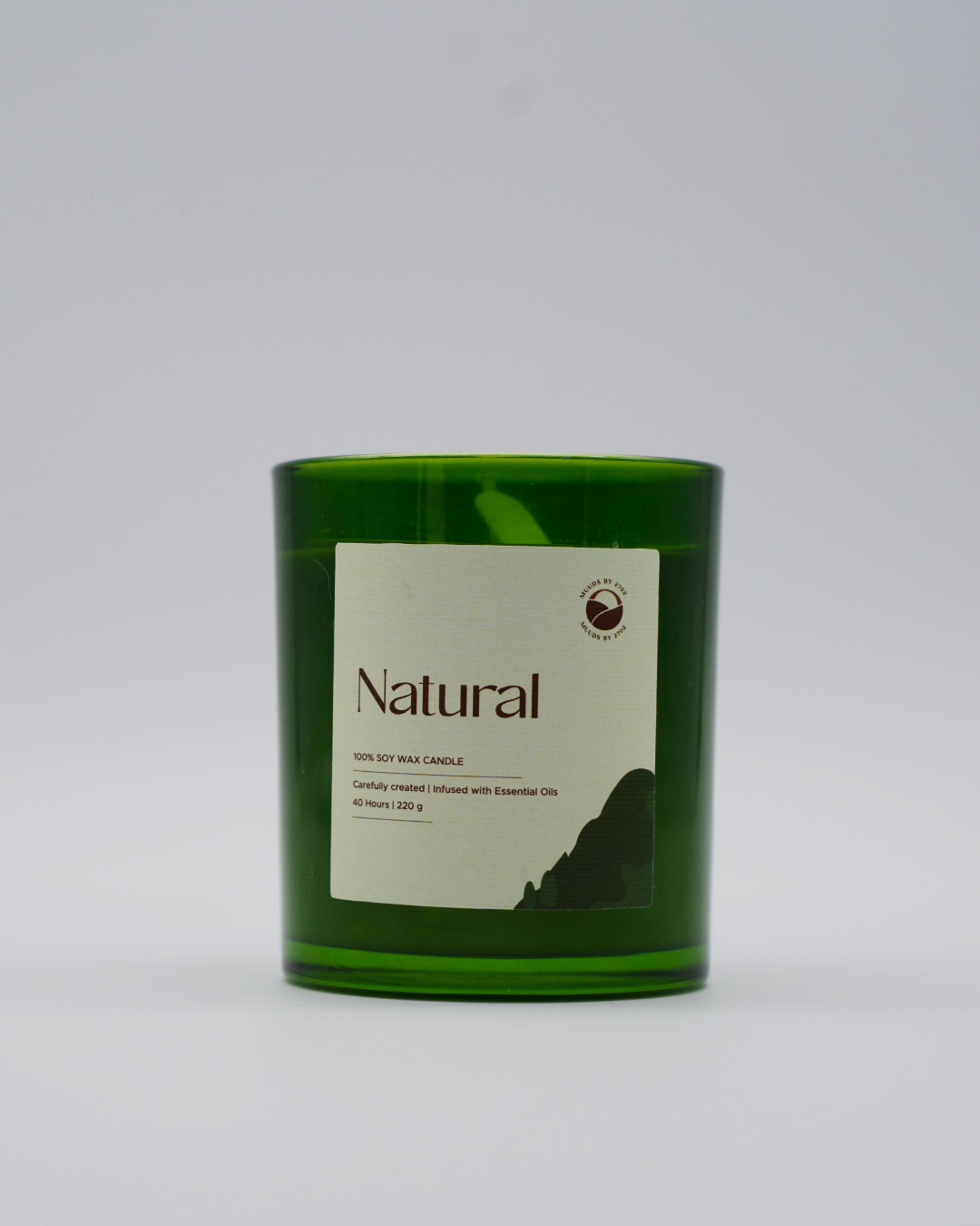 Green candle with a label on a white background