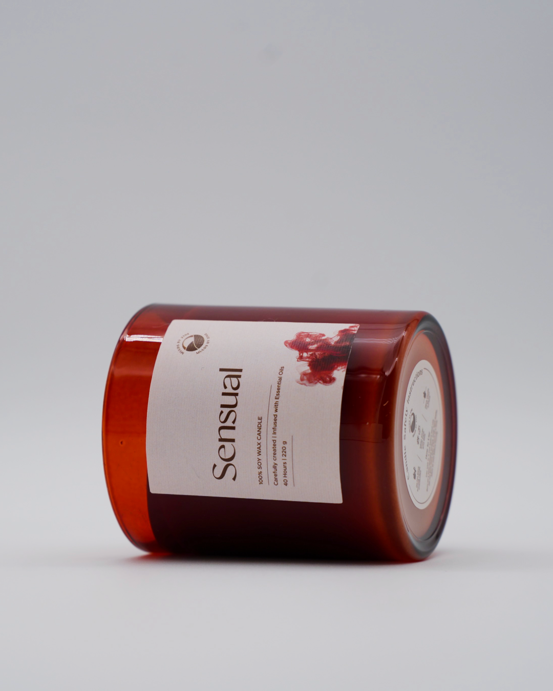 Red candle with a label on a gray background